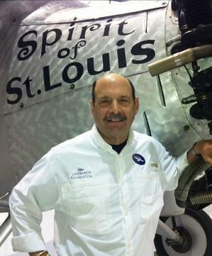 John Petersen, posing infront of "The Sprit of Saint Louis" in a Lindbergh Foundation polo shirt